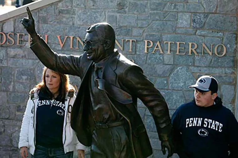 File: Fans get in place for a photo with a statue of former coach Joe Paterno at Penn State's Beaver Stadium. (AP Photo/Alex Brandon