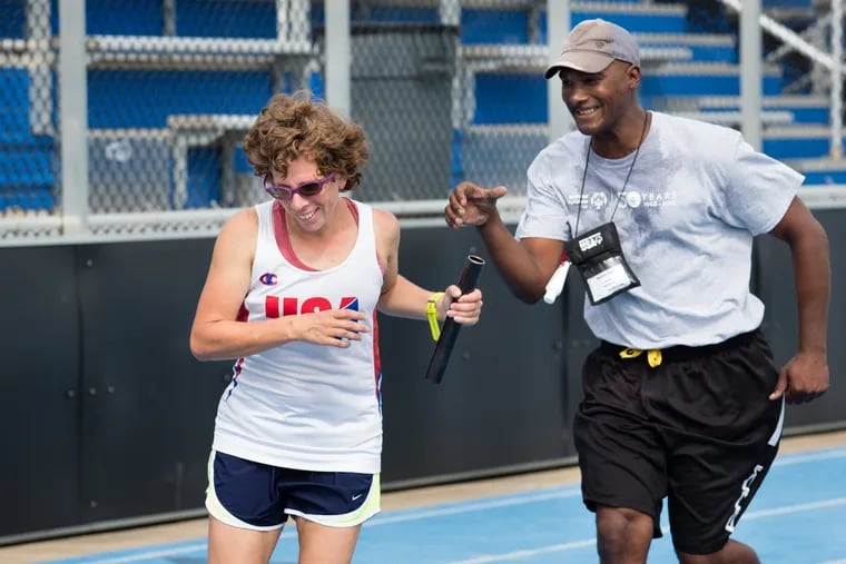 Coach Derrik Ford, of East Haven, Ct., works on baton handoffs with athlete Karen Dickerson, of Springfield, Va., during track practice for the Special Olympics USA national team Thursday in Newark, Del. Hundreds of athletes from the Special Olympics USA national team are training at University of Delaware in preparation for competition in the Special Olympics World Games Abue Dhabi 2019 next March. .