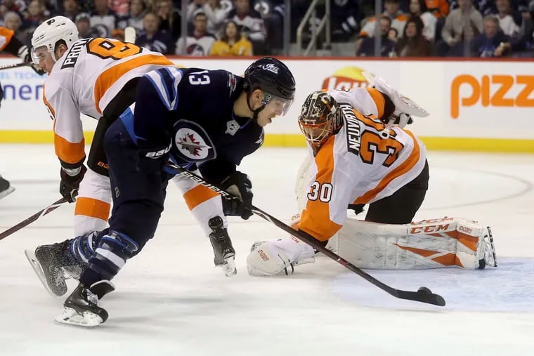Brandon Tanev scores past Flyers goaltender Michal Neuvirth on Sunday. (Trevor Hagan / The Canadian Press)