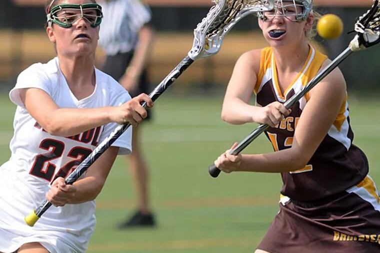 Archbishop Carroll's Isabelle Schmitt (left) and St. Hubert's Nicole Hawe (right) both go for the ball in Catholic League girls' lacrosse semifinals at Neumann University May 16, 2013. (Tom Gralish/Staff Photographer)