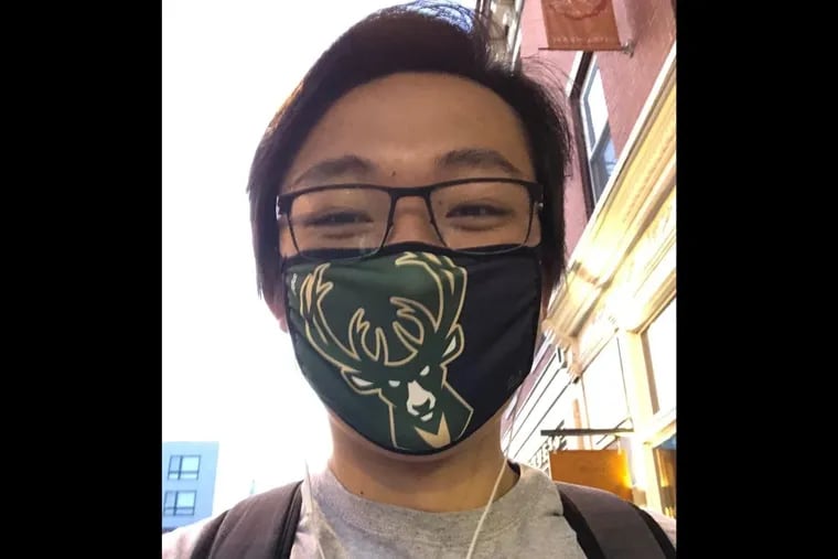 Tong Wang, a University of Pennsylvania medical student, writes about why he purposefully wears a mask with a sports logo on it so people will know he's an American, amid rising racism against Asian Americans during the coronavirus pandemic.