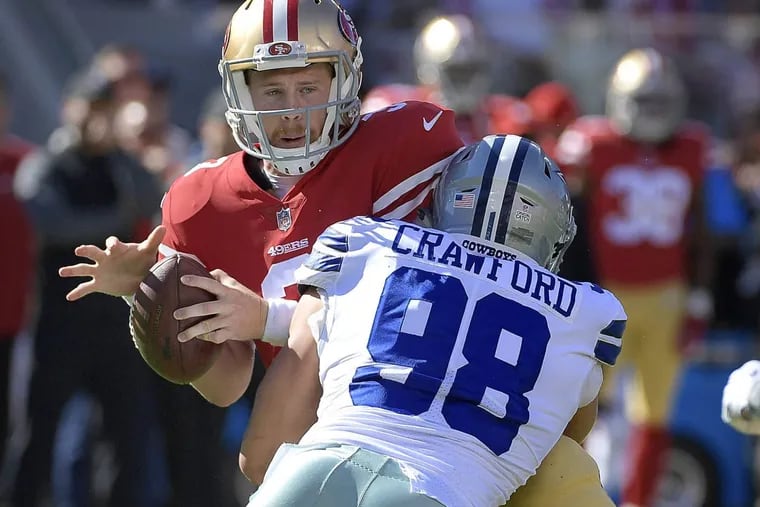 San Francisco 49ers quarterback C.J. Beathard (3) is sacked by Dallas Cowboys defensive end Tyrone Crawford during the second quarter Sunday.