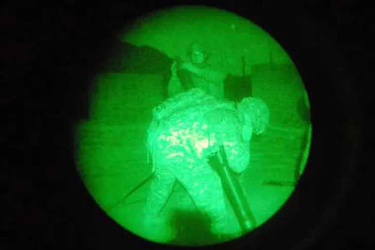 Seen through night vision goggles, artillerymen fire mortar shells in the direction of where the Taliban fires rockets outside Forward Operating Base Kala Gush. (Matt Katz / Staff)