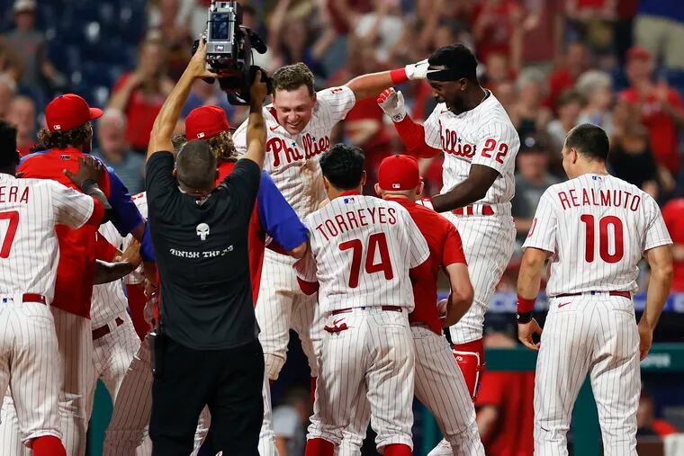 Phillies Andrew McCutchen leaps into his teammates after hitting the game winning walk-off three run home run..