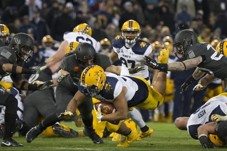 December 10, 2016: Navy Midshipmen fullback Shawn White (31) goes airborne during the 117th edition of The Army-Navy game between The Army Black Knights and The Navy Midshipmen at M&T Bank Stadium Stadium in Baltimore, MD. The Army Black Knights defeat The Navy Midshipmen 21-17. The Army Black Knights end a fourteen year losing streak.