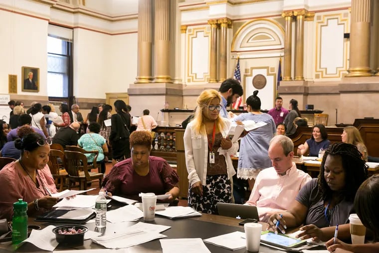 Inside Courtroom 676 in Philadelphia City Hall, a group of volunteer housing counselors gather around a table on Thursdays. Together with pro bono attorneys, they try to help homeowners stave off foreclosure through Philadelphia's Residential Mortgage Foreclosure Diversion program.
