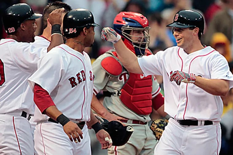 Boston Red Sox's Daniel Nava, right, celebrates his grand slam, which he hit in his first major league at bat.  (AP Photo/Michael Dwyer)