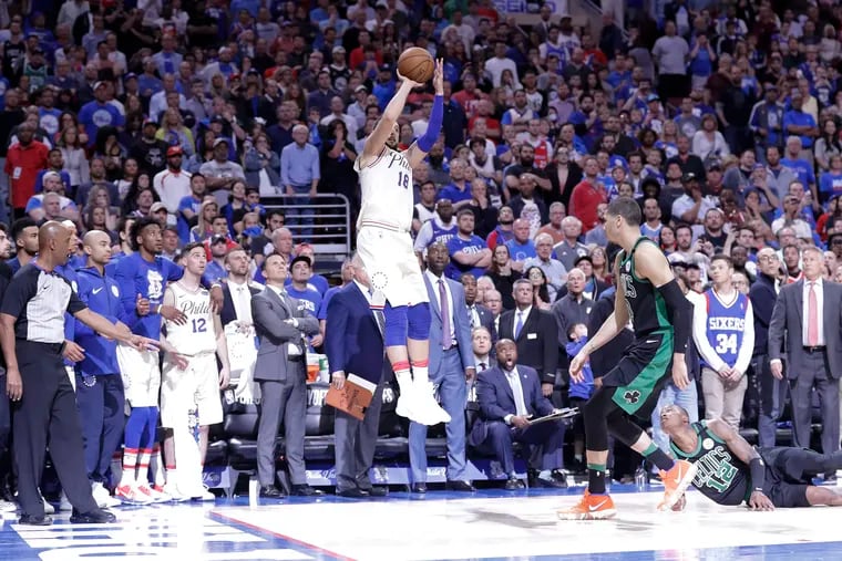 Sixers guard Marco Belinelli shoots the game tying basket late in the fourth-quarter past Celtics forward Jayson Tatum and guard Terry Rozier.