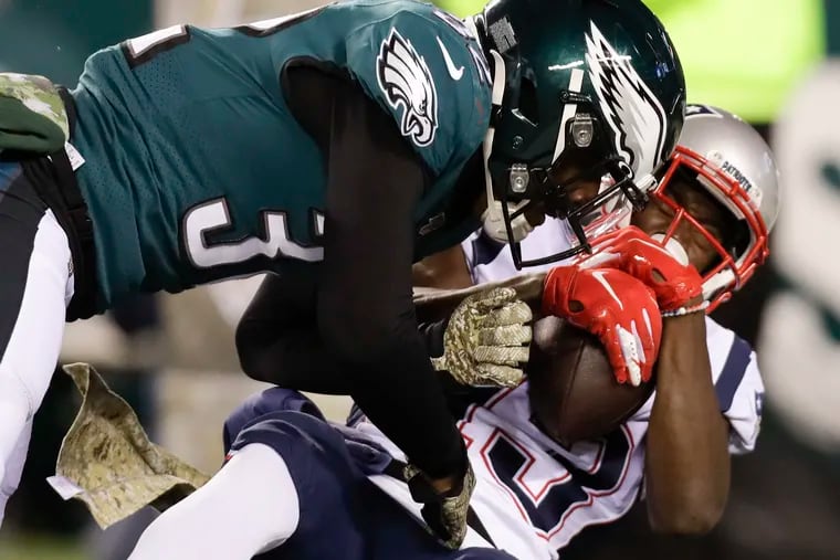 Eagles cornerback Rasul Douglas lands a hit on New England Patriots wide receiver Phillip Dorsett during the third quarter.