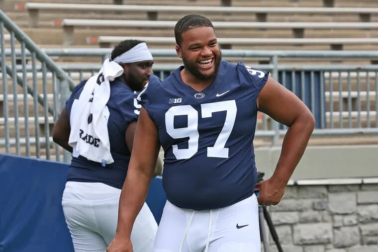 Penn State defensive lineman PJ Mustipher (97) shares a laugh with offensive lineman Rasheed Walker (53) during the team's Media Day on Aug. 7, 2021.
