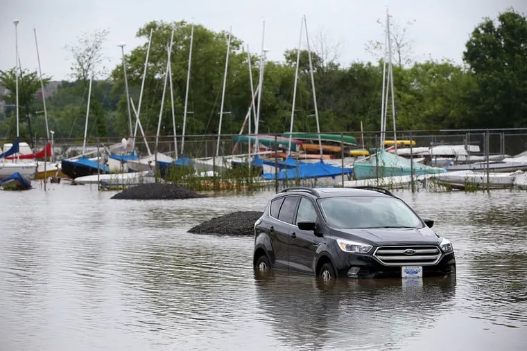 A car is partially submerged in floodwaters in front of boats stored at the Cooper River Yacht Club in Collingswood, N.J., on Thursday, June 20, 2019. Overnight flash flooding impacted a number of South Jersey communities Thursday.