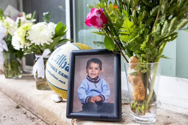 A childhood picture of Nicolas Elizalde is part of a memorial in front of his Havertown home. Elizalde, 14, was fatally shot outside Roxborough High School after a football scrimmage on Sept. 27.