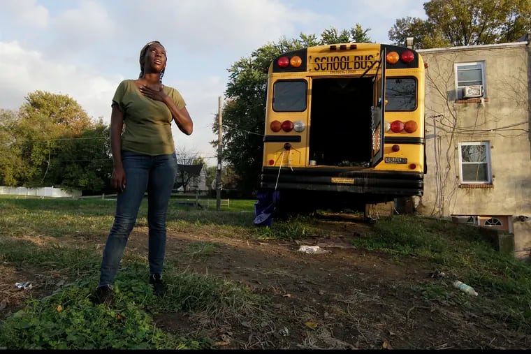 (L-R) Dominique London, her school bus and her grandmothers former house in Phila., on Oct. 22, 2020. London is repurposing a school bus into her home on wheels. The bus sits now on her plot of land she saved from sheriff's sale, next door to her grandmother's house which was lost to sheriff's sale