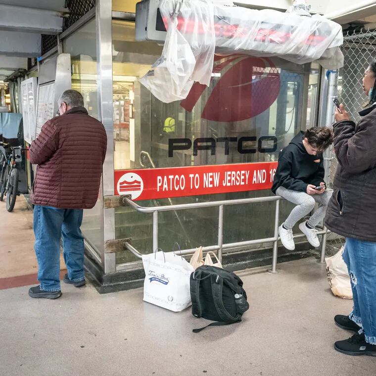 People wait at the 8th and Market PATCO station after service was suspended because of Friday's earthquake.