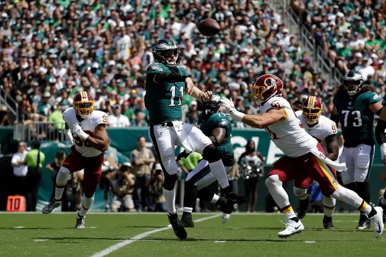 Eagles quarterback Carson Wentz under pressure by Washington outside linebacker Ryan Kerrigan during the first quarter of the game on Sunday, September 8, 2019 in Philadelphia.