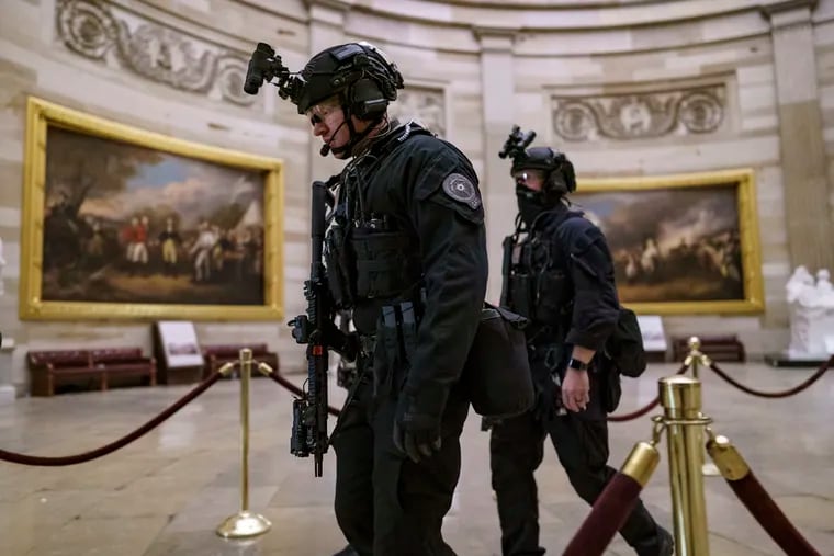 Members of the U.S. Secret Service Counter Assault Team walk through the U.S. Capitol on Jan. 6, 2021.