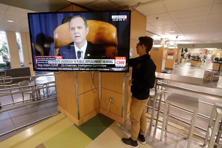 University of Utah student Suyog Shrestha turns on a TV in the student union on the campus in Salt Lake City as Rep. Adam Schiff, the Democratic chairman of the House Intelligence Committee, makes his opening remarks Wednesday, Nov. 13, 2019.