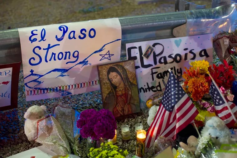 In this Aug. 4, 2019, file photo, a Virgin Mary painting, flags and flowers adorn a makeshift memorial for the 22 victims of the mass shooting at a Walmart in El Paso, Texas. The shooter has been linked to an online manifesto railing against Latino immigrants. Federal authorities say they are handling the shooting as a domestic terror case.