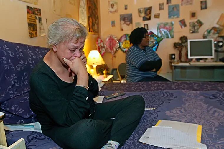 Pamela Campbell, mother of Melissa Thomas, sits on her bed in her home in West Philadelphia, Monday, Feb. 3, 2014. Surrounded by family and friends, she is lost in her own thoughts as people in the room talk about Melissa Thomas.  (MICHAEL BRYANT / Staff Photographer)