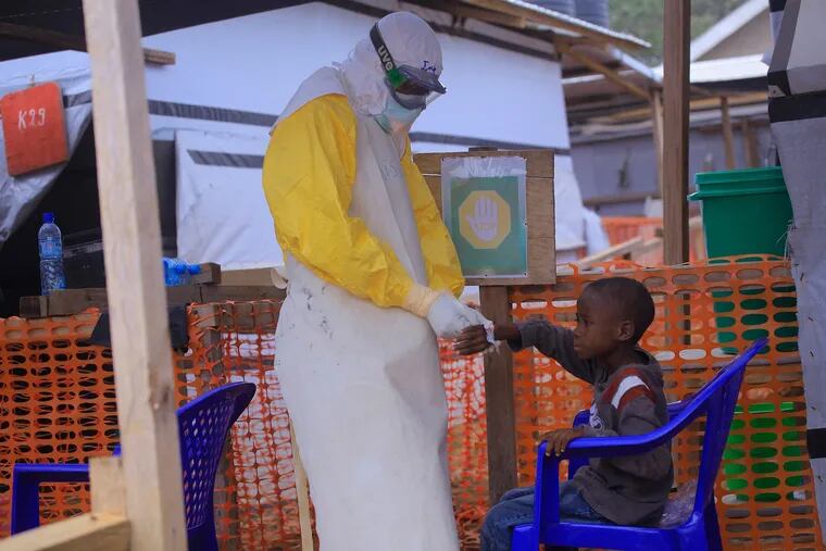 An Ebola nurse at the CTE ALIMA BENI Ebola Treatment Centre cares for a child suspected of having Ebola on May 20, 2019 in Beni, Congo. (Kitsa Musayi/DPA/Abaca Press/TNS)