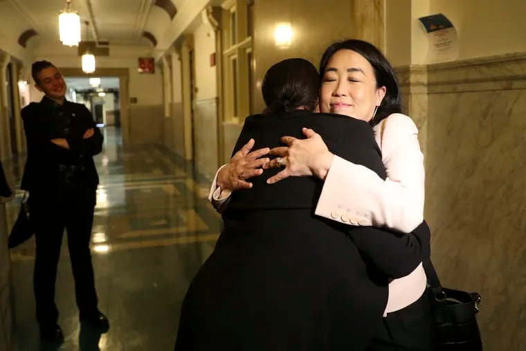 Laron Campbell, a client of Community Legal Services, hugs Philadelphia City Councilmember Helen Gym after the Committee on Law and Government voted in favor of a bill that would provide free legal counsel to low-income tenants in Philadelphia.