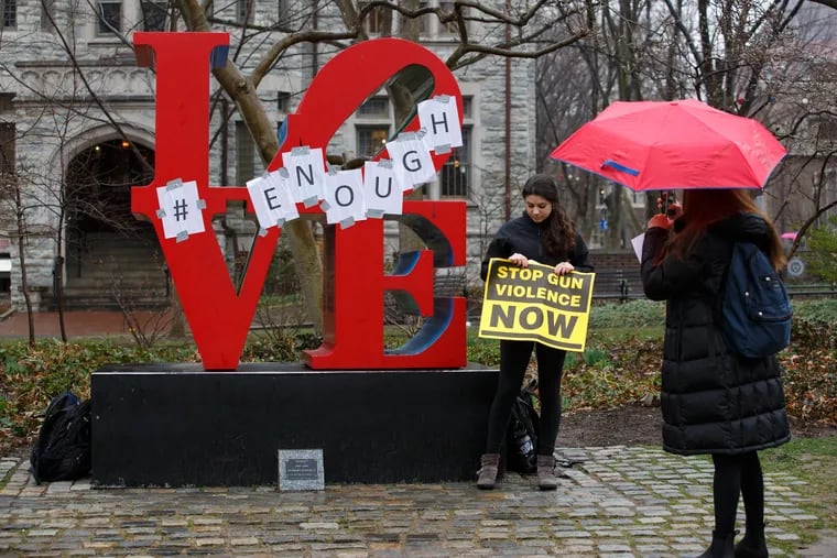 Nicole Rubin poses for a photo with the LOVE statue on Locust Walk, on Penn's campus, after a protest against gun violence last year.