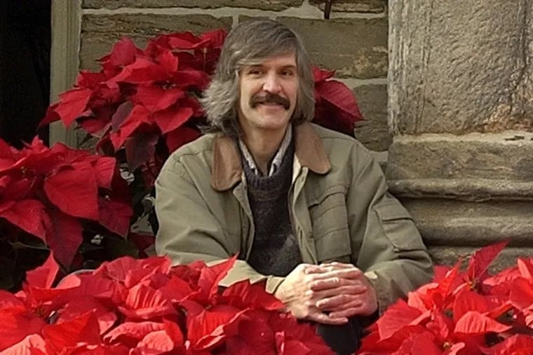 Mr. Fry wrote extensively about the history of poinsettias in Philadelphia. Here, he poses among them in 2003.