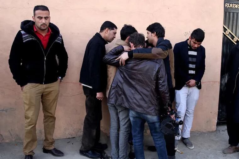 MASSOUD HOSSAINI / ASSOCIATED PRESS Afghan friends of journalist Zubair Hatami, who died in a Taliban attack, mourn at his funeral Sunday.