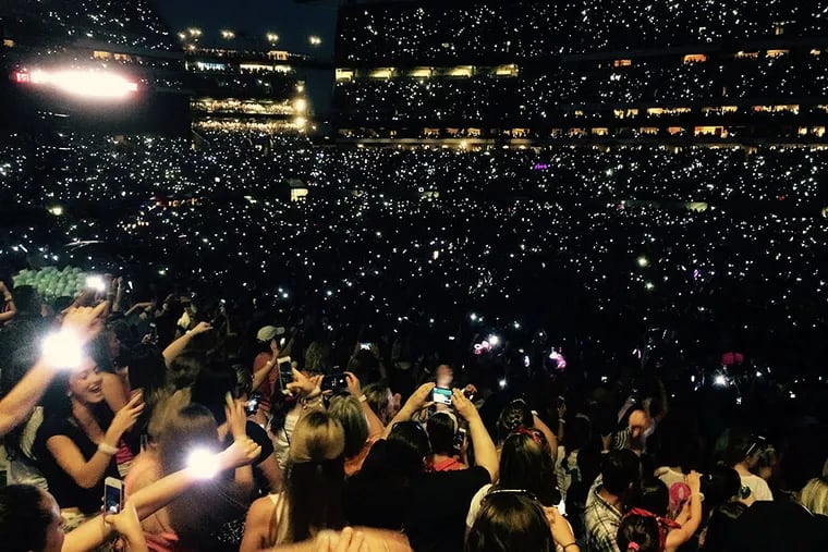 PixMob LED bracelets light up Lincoln Financial Field during Taylor Swift’s "1989 World Tour" concert Friday night. At times, half the wristlets blinked in beat on “one” and “three” while others blinked on "two" and "four." JONATHAN TAKIFF / Staff