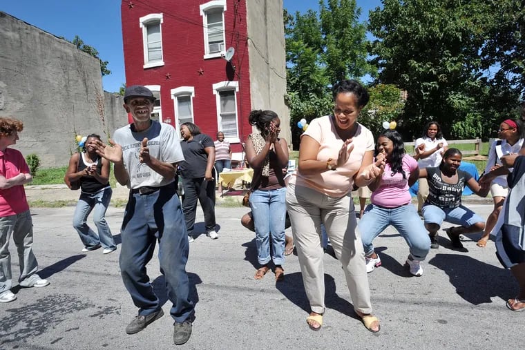 Vaux Roberts High School in Philadelphia threw a block party for the community, and they were dancing in the streets. In the front of the line are Larry Brooks(left), community volunteer and Ruth Birchett, of the School Advisory Council.