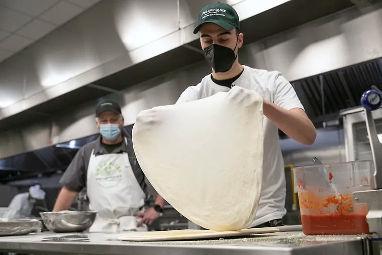 Ben Berman shapes pizza dough before making a pie at the Philabundance Community Kitchen in North Philadelphia on Wednesday, Feb. 23, 2022. Berman is handing over his Good Pizza brand to Philabundance.