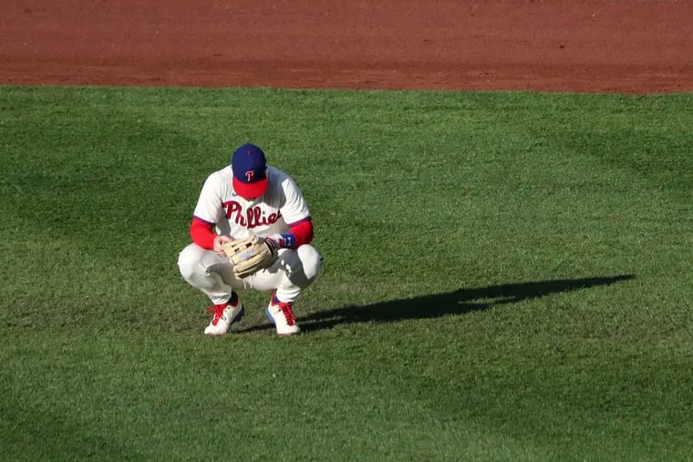 Phillies right fielder Bryce Harper squats during the seventh inning of Sunday's game against the Blue Jays.