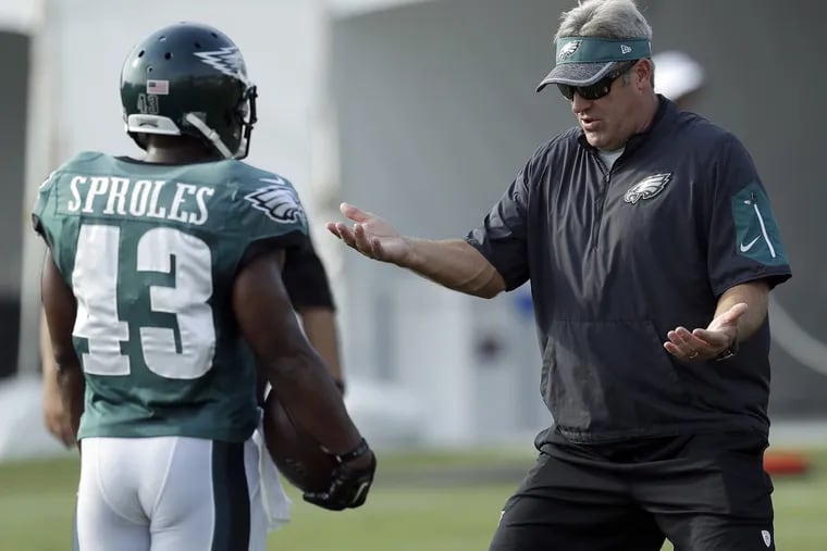 Eagles Head Coach Doug Pederson works with Darren Sproles during training camp at the NovaCare Complex on Saturday, July 30, 2016. YONG KIM / Staff Photographer