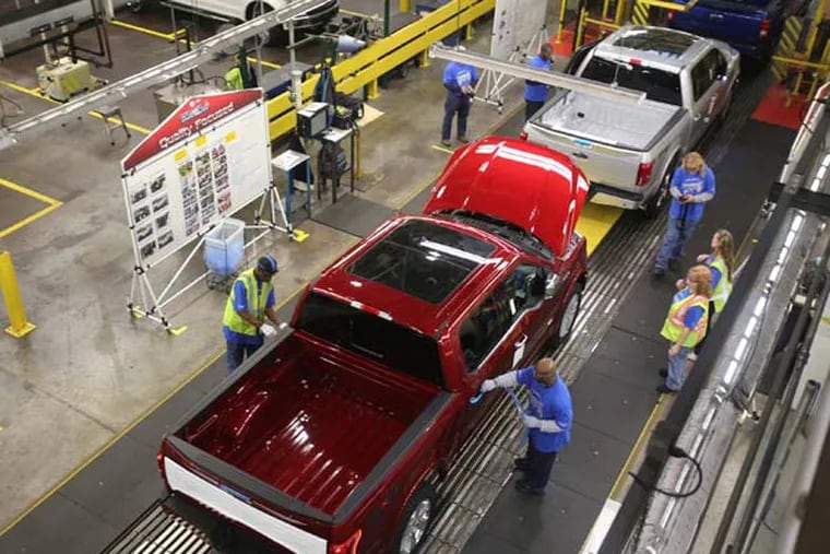 Workers inspect and go over the brand new 2015 Ford F-150 as it processes down the line on Tuesday, Nov. 11, 2014, in Dearborn, Mich. (Regina H. Boone/Detroit Free Press/TNS)