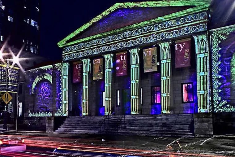 The University of the Arts' Dorrance Hamilton Hall at Broad and Pine Sts.. illuminated by a projection created by Artlumiere.  View is facing west. Time exposure results in vehicle's lights leaving trails on Broad street.  (David M Warren/Inquirer)  EDITORS NOTE:  PLIGHT23Pi 98240 PHILADELPHIA 11/20/07   Last year the Center City District sponsored a holiday lighting program that bathed City Hall in changing pastel shades. This year, the district is moving the show to South Broad on the Avenue of the Arts with a difference: the display will use differently types of lighting technology and the public will be urged to vote on which they like best.   9/
