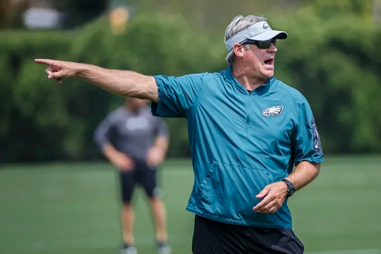 Eagles head coach Doug Pederson directs a passing drill during Monday's practice at the NovaCare Center on August 27, 2018. MICHAEL BRYANT / Staff Photographer