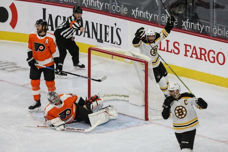 Flyers' goalie Carter Hart sprawled on the ice after the Bruins scored a power-play goal April 6 at the Wells Fargo Center.