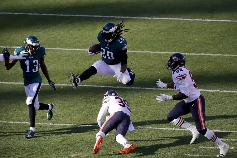 Eagles’ LeGarrette Blount leaps over the Bears’ Eddie Jackson on a second-quarter in the Eagles’ win on Sunday.