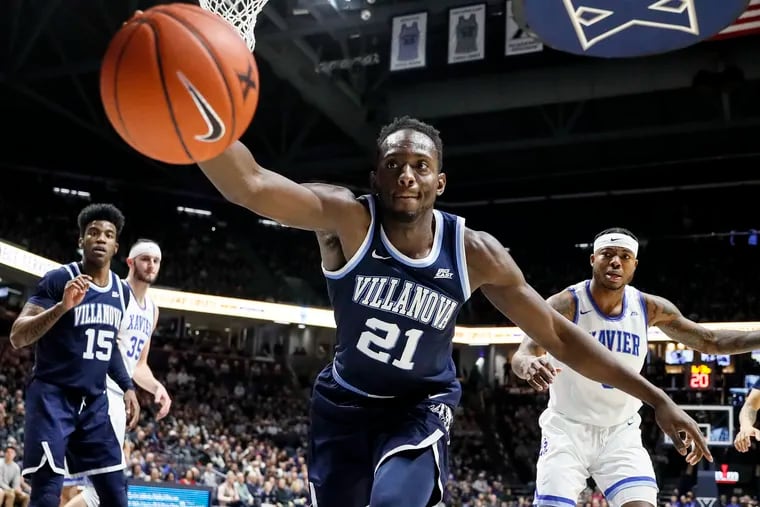 Villanova's Dhamir Cosby-Roundtree (21) reaches for a rebound in the first half of an NCAA college basketball game against Xavier, Sunday, Feb. 24, 2019, in Cincinnati. (AP Photo/John Minchillo)