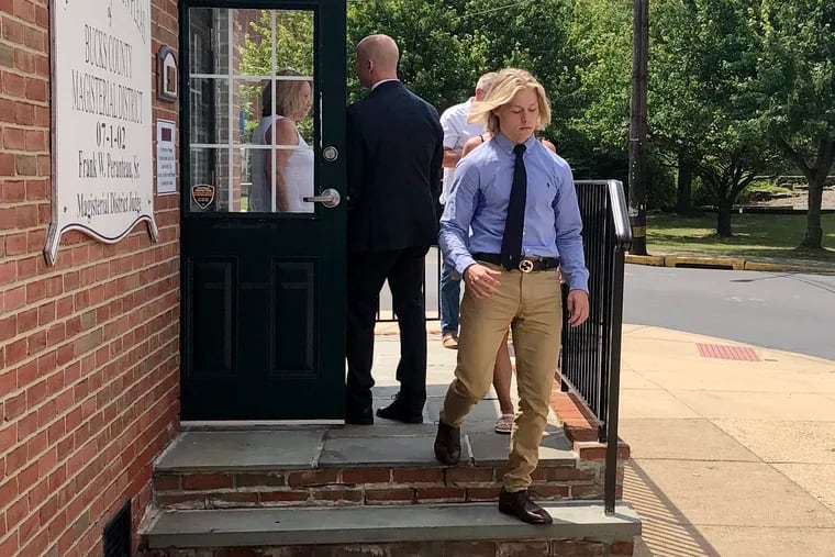 Kevin Baker Jr. (right) exits a magisterial district judge's office in Bristol after his preliminary hearing Wednesday. Baker is accused of hitting John Dugan with his pickup truck on Christmas Eve and fleeing the scene.