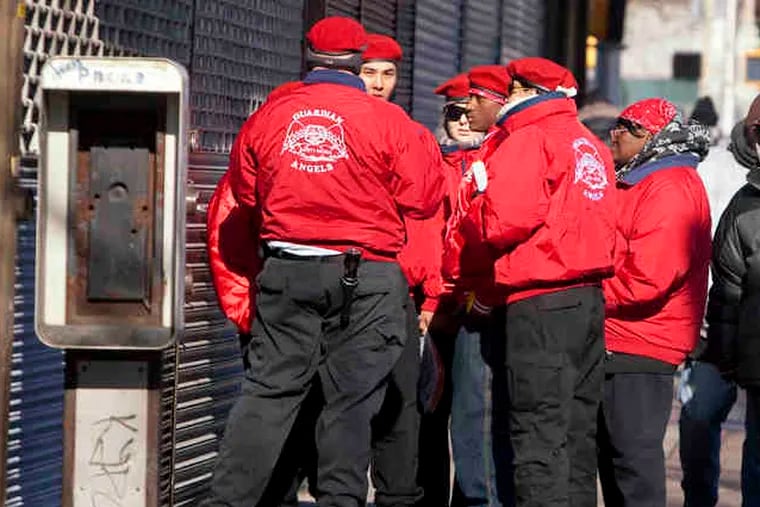 A group of Guardian Angels piques the curiosity of some pedestrians on Broadway in Camden. More than 40 members came from other cities, and the group is recruiting locally. Story, B4.