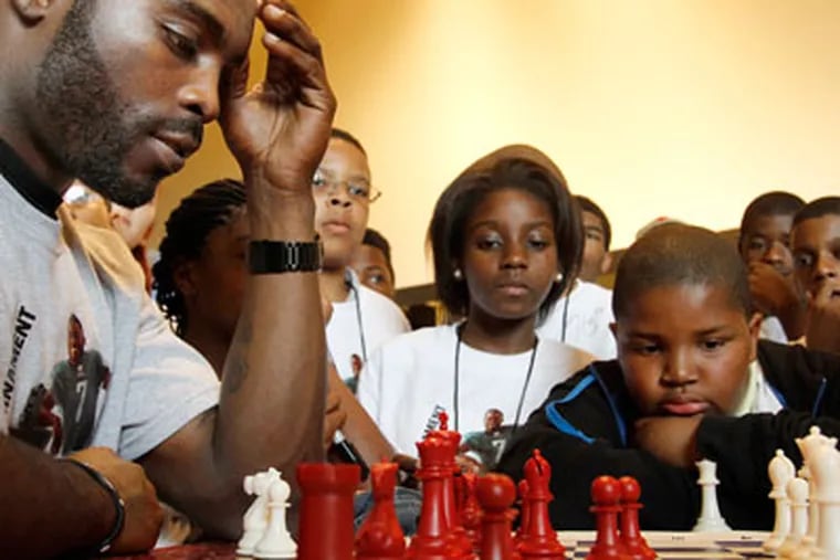 Michael Vick squared off against young chess players at Lincoln Financial Field on Tuesday. (Michael S. Wirtz/Staff Photographer)