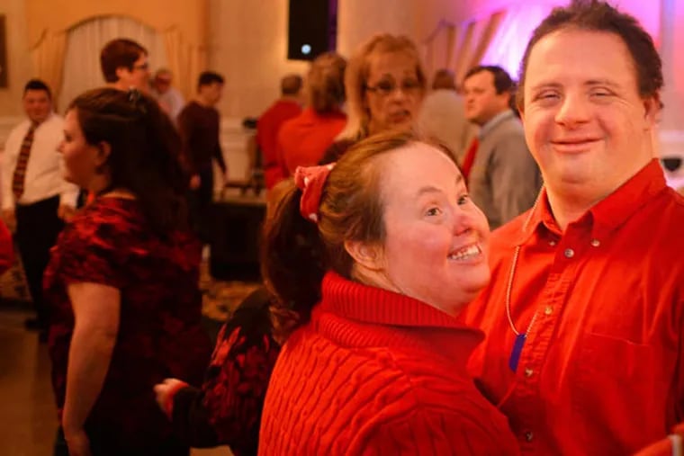 Kelley Sanonsen of Voorhees and longtime friend David Praiss of Haddon Heights enjoy themselves at the latest dance for the developmentally disabled hosted by Camden County. (TOM GRALISH / Staff Photographer)