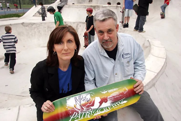 Liz and Pearse Kerr with a skateboard bearing son Patrick’s name at the skate park in Roslyn that he had been raising money to build when he died in 2002. (David Swanson / Staff Photographer)