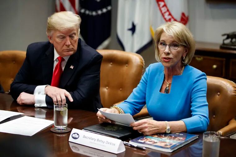 President Donald Trump listens as Secretary of Education Betsy DeVos speaks during a roundtable discussion on the Federal Commission on School Safety report, in the Roosevelt Room of the White House, Tuesday, Dec. 18, 2018, in Washington. (AP Photo/Evan Vucci)