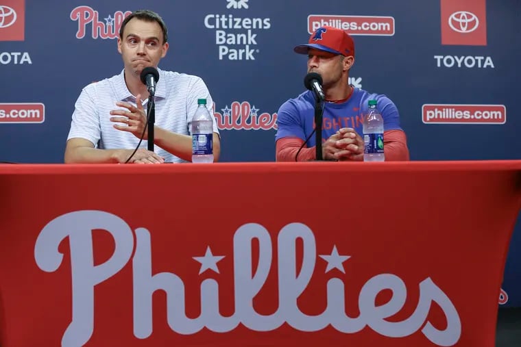 Phillies general manager Matt Klentak, left, and manager Gabe Kapler talk to the media about the firing of hitting coach John Mallee and the hiring of Charlie Manuel to replace him.