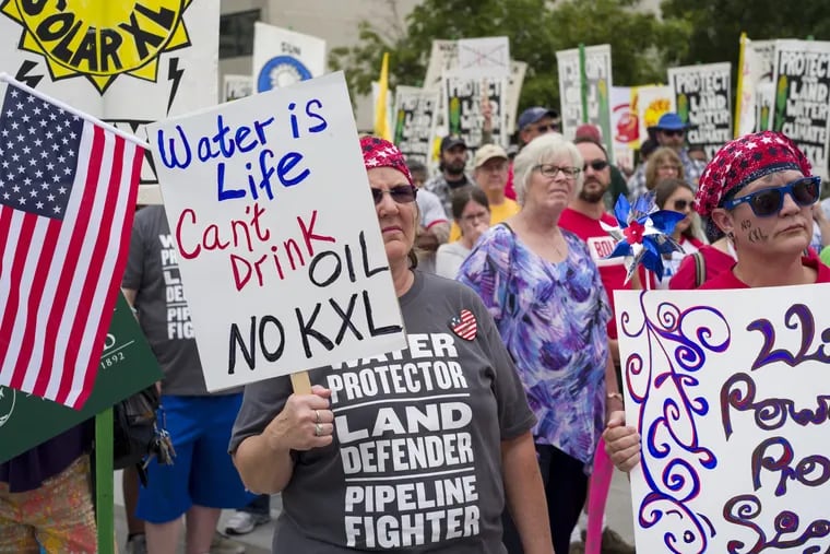 In this Aug. 6, 2017, file photo, demonstrators against the Keystone XL listen to speakers in Lincoln, Neb.