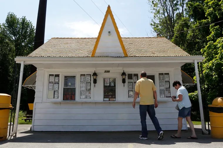 Mike Hiltebrand and his wife Christine Andrusiw prepare to order soft serve ice cream, aka 'custard,' at Pennsville Custard on Route 49,  just south of where the state highway starts near the Delaware Memorial Bridge approach. The landmark business with the distinctive yellow roof opened in 1952, the year after the bridge did. 