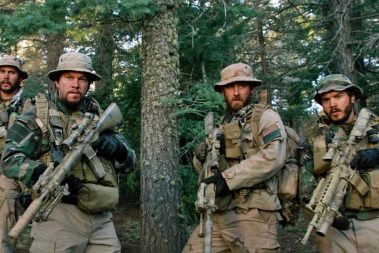This photo released by Universal Pictures shows, from left, Taylor Kitsch, as Michael Murphy, Mark Wahlberg as Marcus Luttrell, Ben Foster as Matt Axelson, and Emile Hirsch as Danny Dietz in a scene from the film, "Lone Survivor." In the age of the superhero, the movies' most reliable real-life hero has been the Navy SEAL. "Lone Survivor," is the latest in a string of films, including "Zero Dark Thirty" and "Act of Valor" to honor the Navy's special operations force with as much faithfulness as the filmmakers could muster. (AP Photo/Universal Pictures)