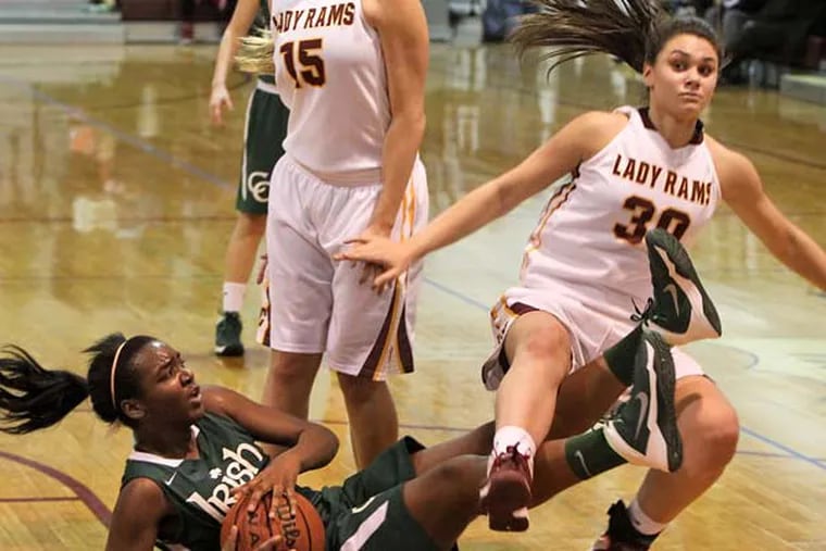 Camden Catholic's Michelle Obasi gets the rebound after tangling with Gloucester Catholic's Mary Gedaka.  (David M Warren/Staff Photographer)